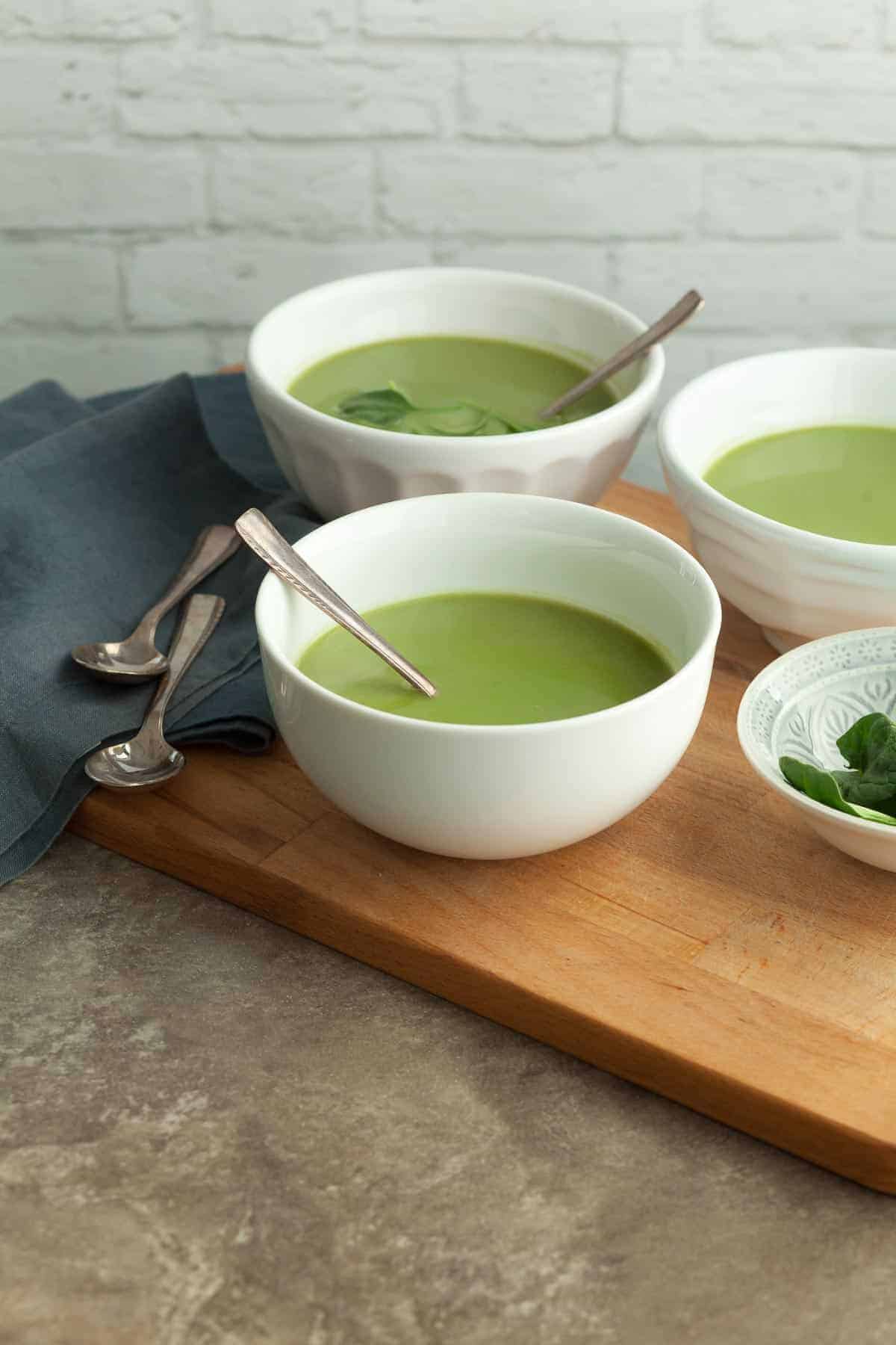 Broccoli Spinach Soup in bowls on board