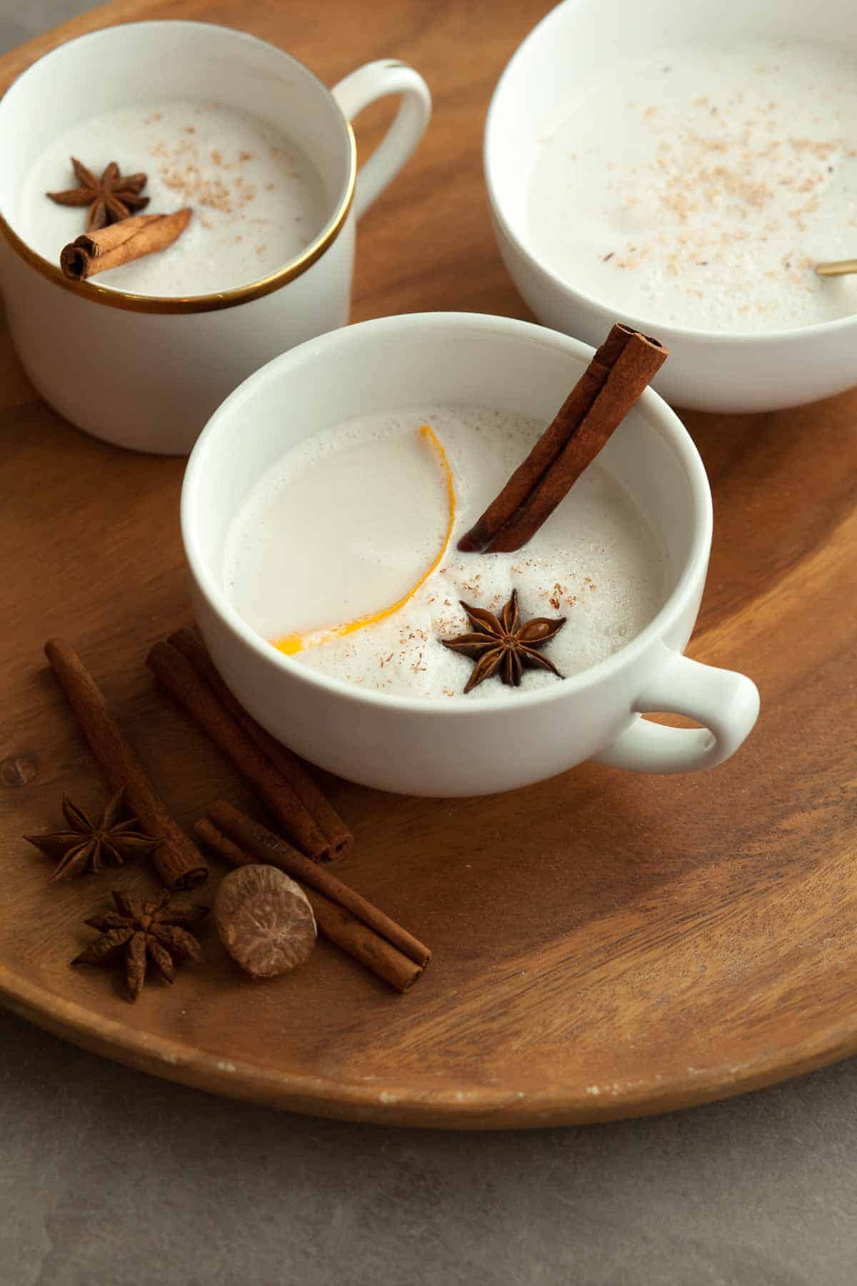 Vegan Warm Spiced Cashew Coconut Milk in Mugs on Wood Serving Tray