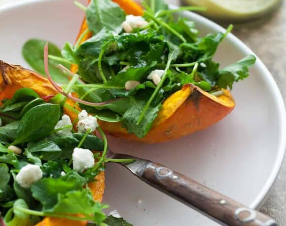 A mix of dark leafy greens are served on thick wedges of roasted squash and topped with goat cheese.