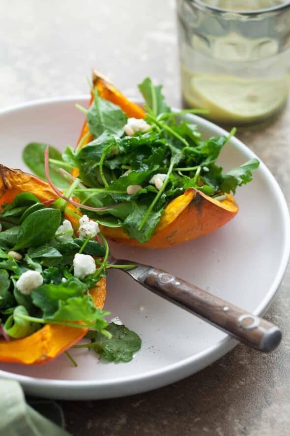 Roasted Winter Squash Salad Boats with Goat Cheese and Pine Nuts on Plate with Fork