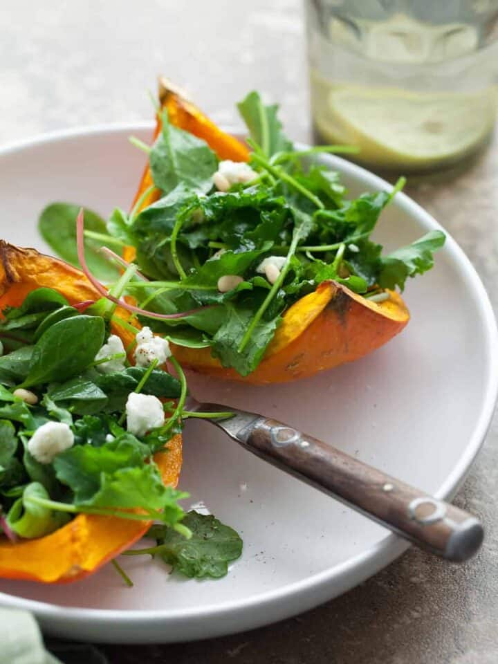 A mix of dark leafy greens are served on thick wedges of roasted squash and topped with goat cheese.
