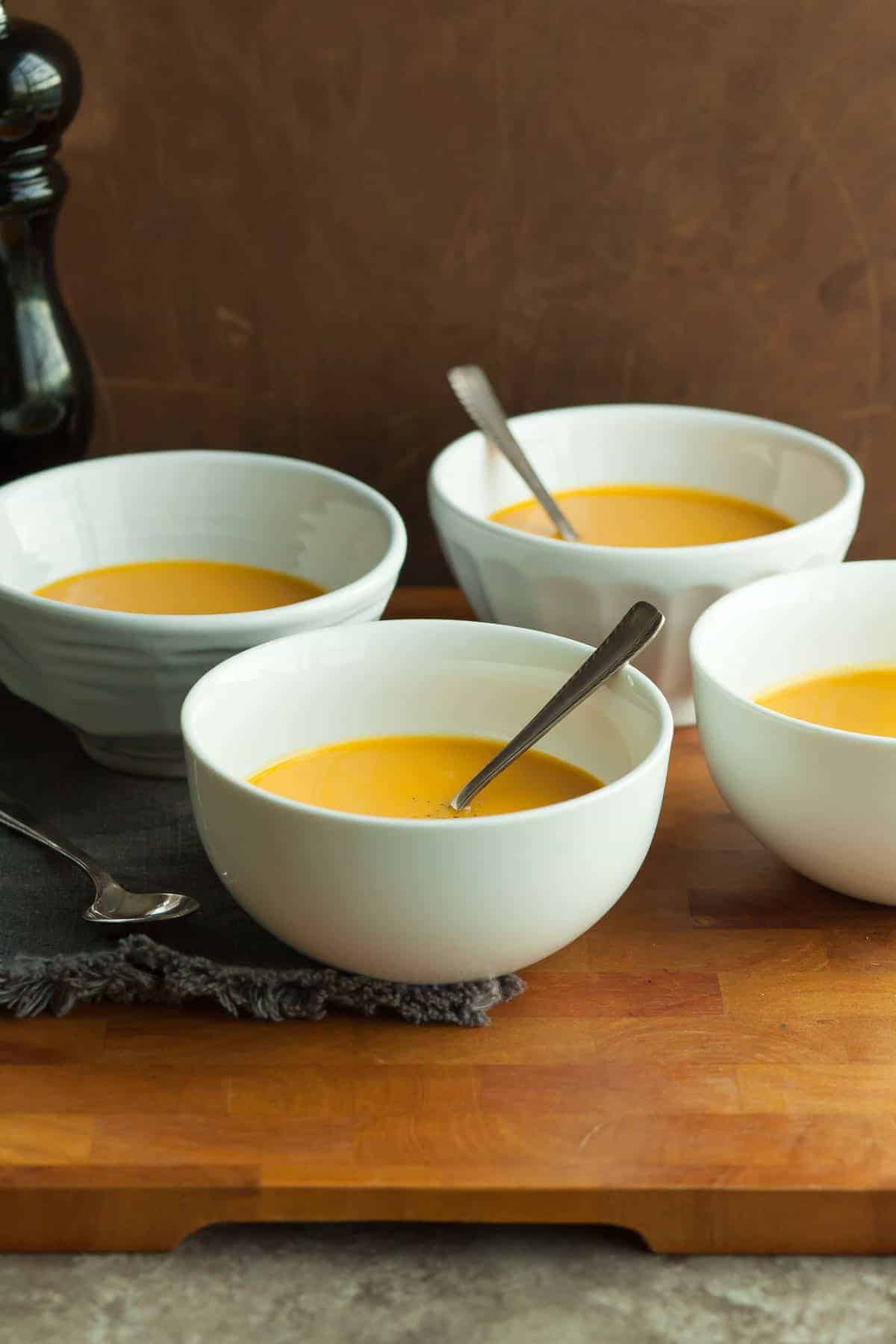 Carrot Ginger Turmeric Soup in bowls with spoons