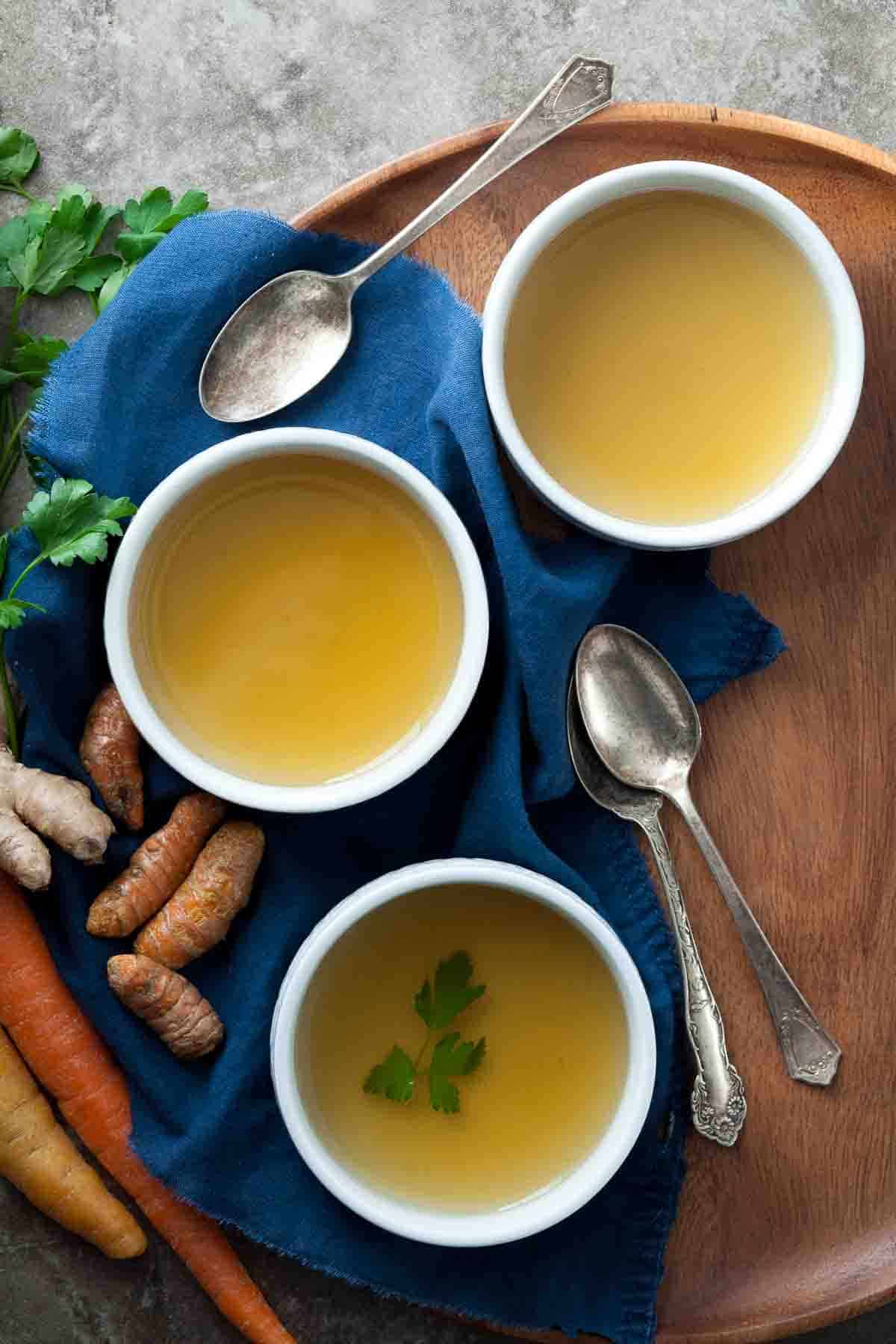 vegetable broth in small bowls on tray