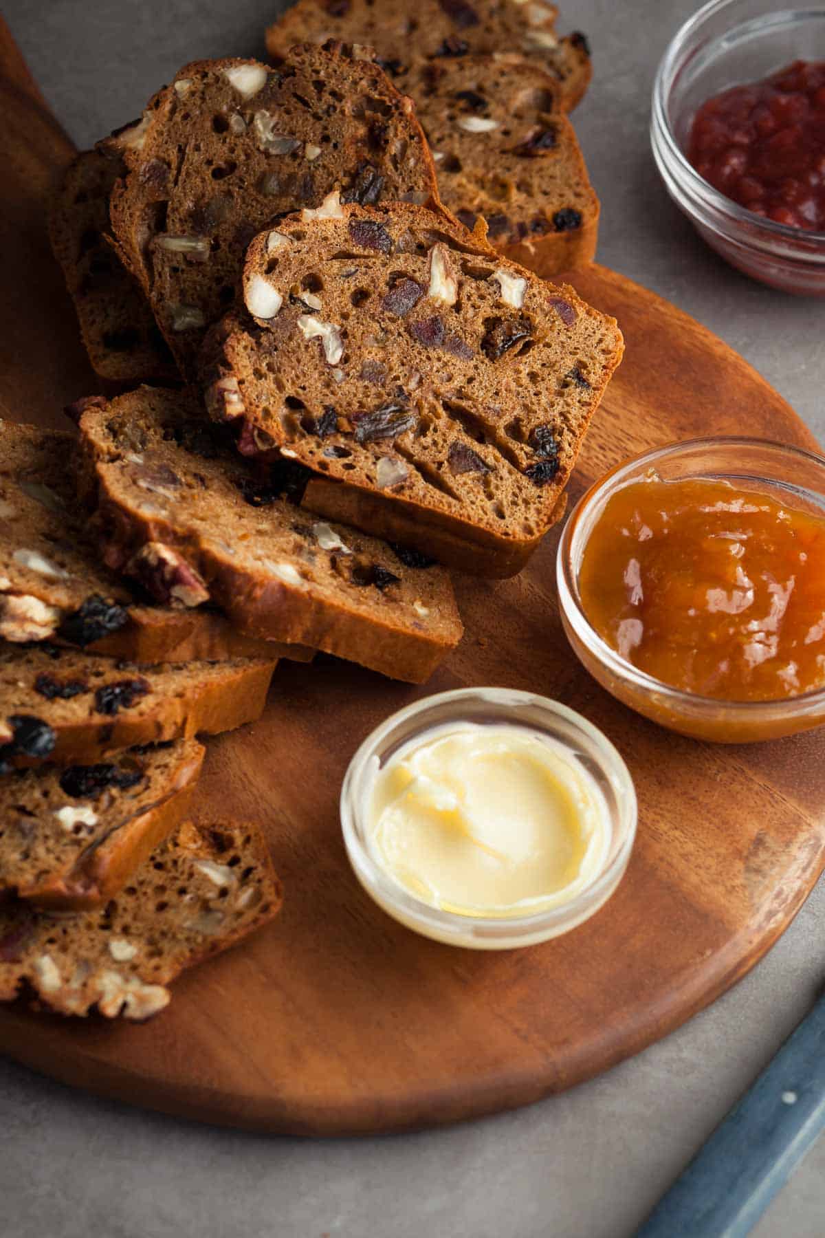 Fruit and Nut Bread Sliced next to jam and butter