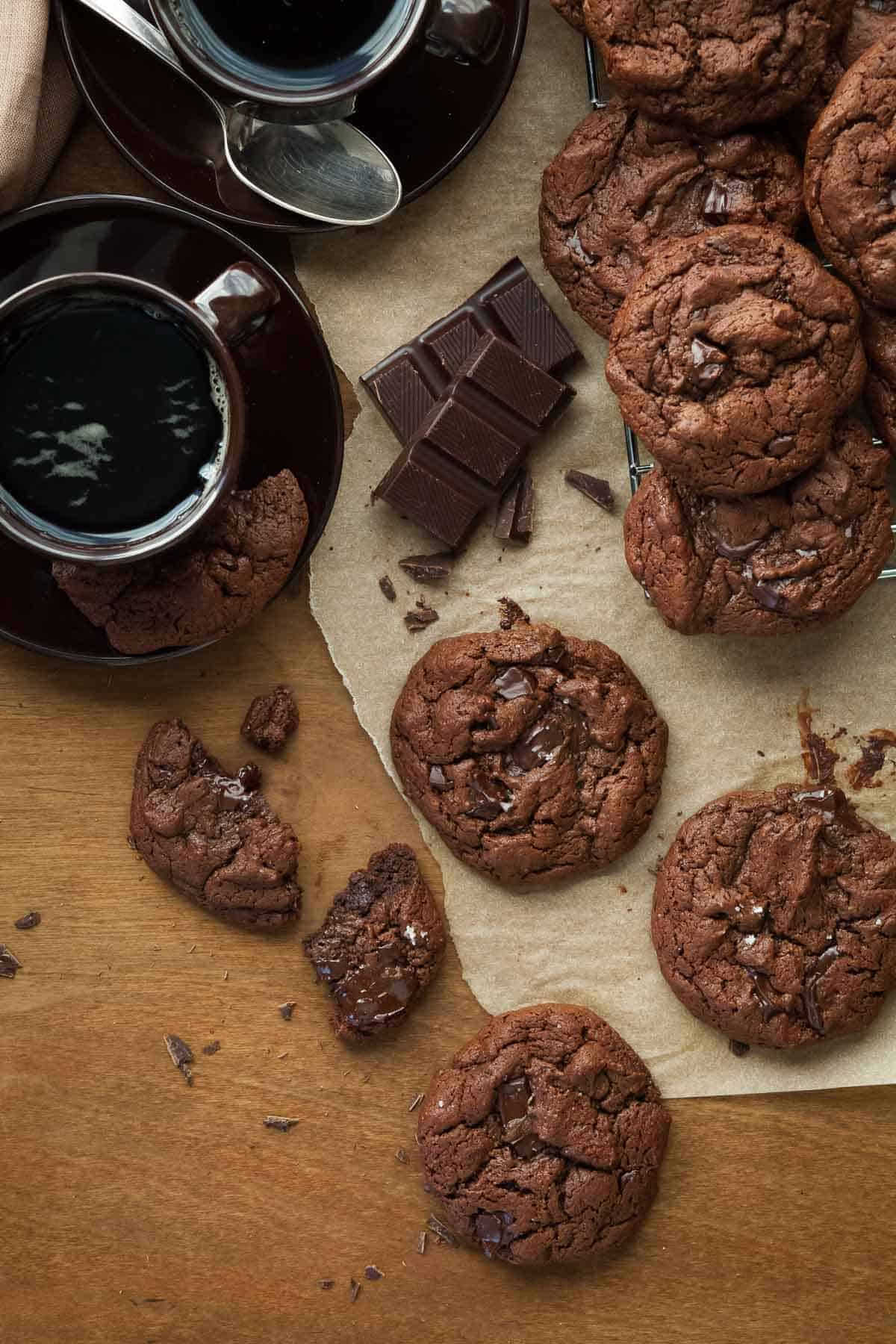 Paleo Double Chocolate Cookies on Parchment with Coffee Cups