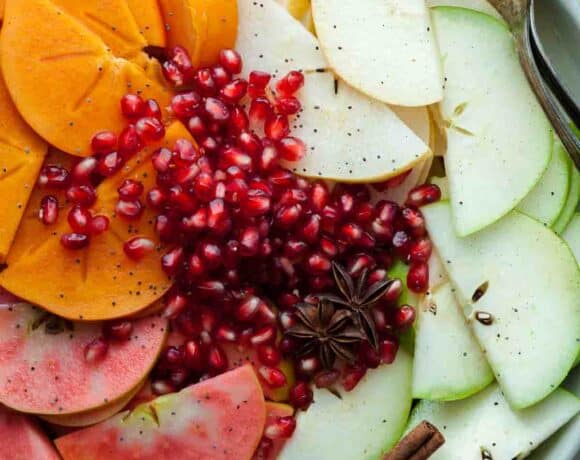A holiday fruit salad filled with apples, pears, persimmons, pomegranate seeds and seasonal spices.