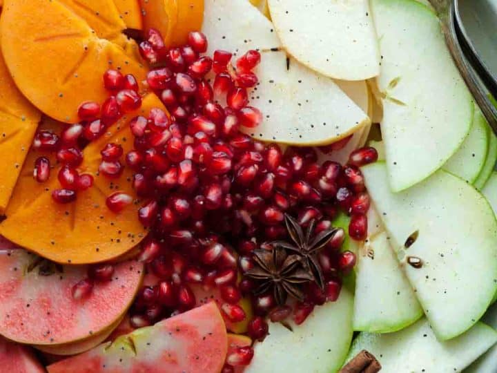 A holiday fruit salad filled with apples, pears, persimmons, pomegranate seeds and seasonal spices.