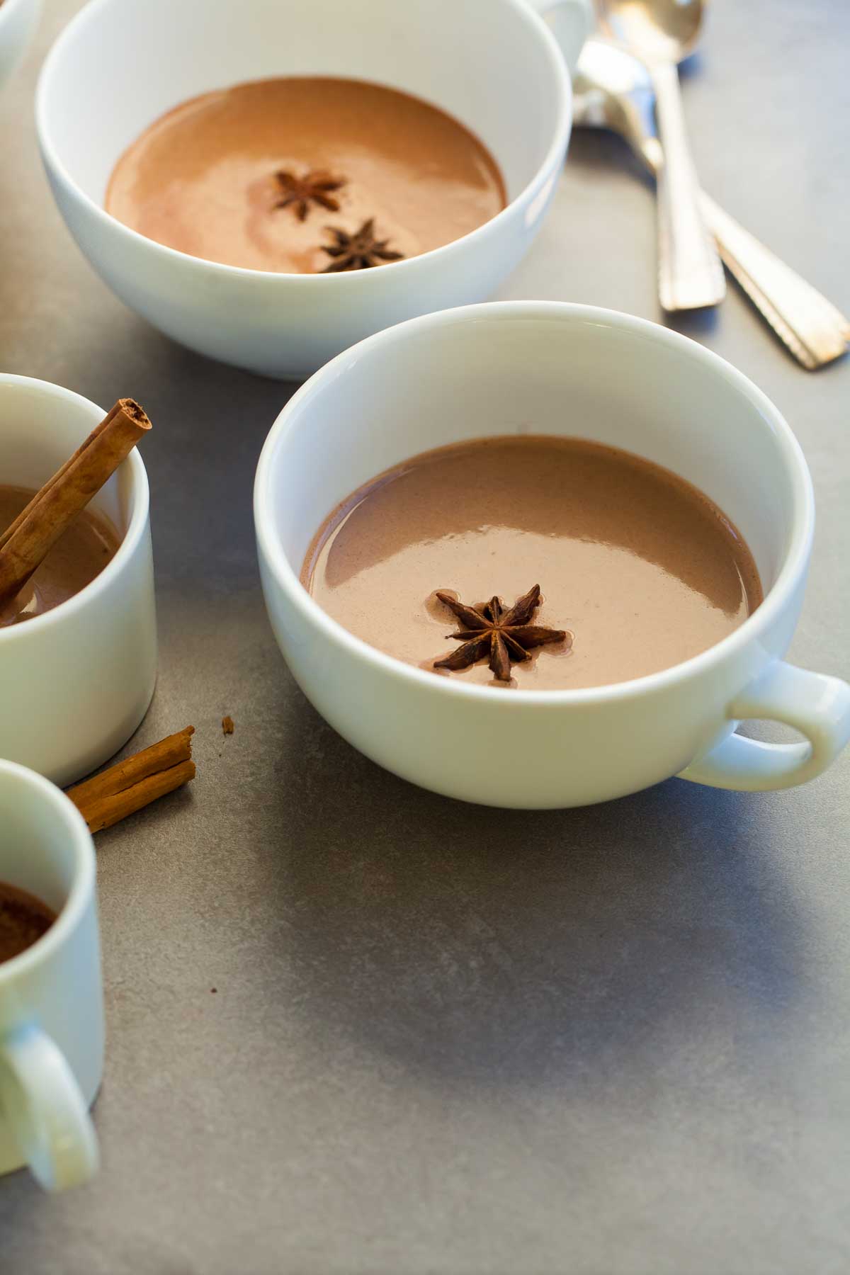 Chinese 5 spice hot chocolate in cups with cinnamon sticks