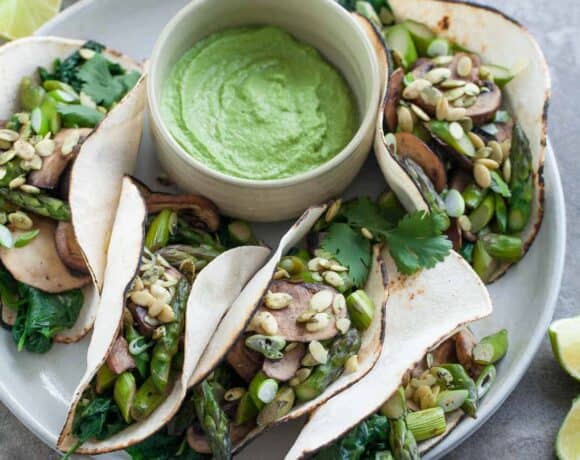 Mushroom Asparagus Tacos with Jalapeno Cashew Crema (Paleo, Vegan) - These paleo and vegan asparagus, mushroom and spinach filled tacos pack a flavorful punch thanks to a creamy jalapeno and cilantro crema.