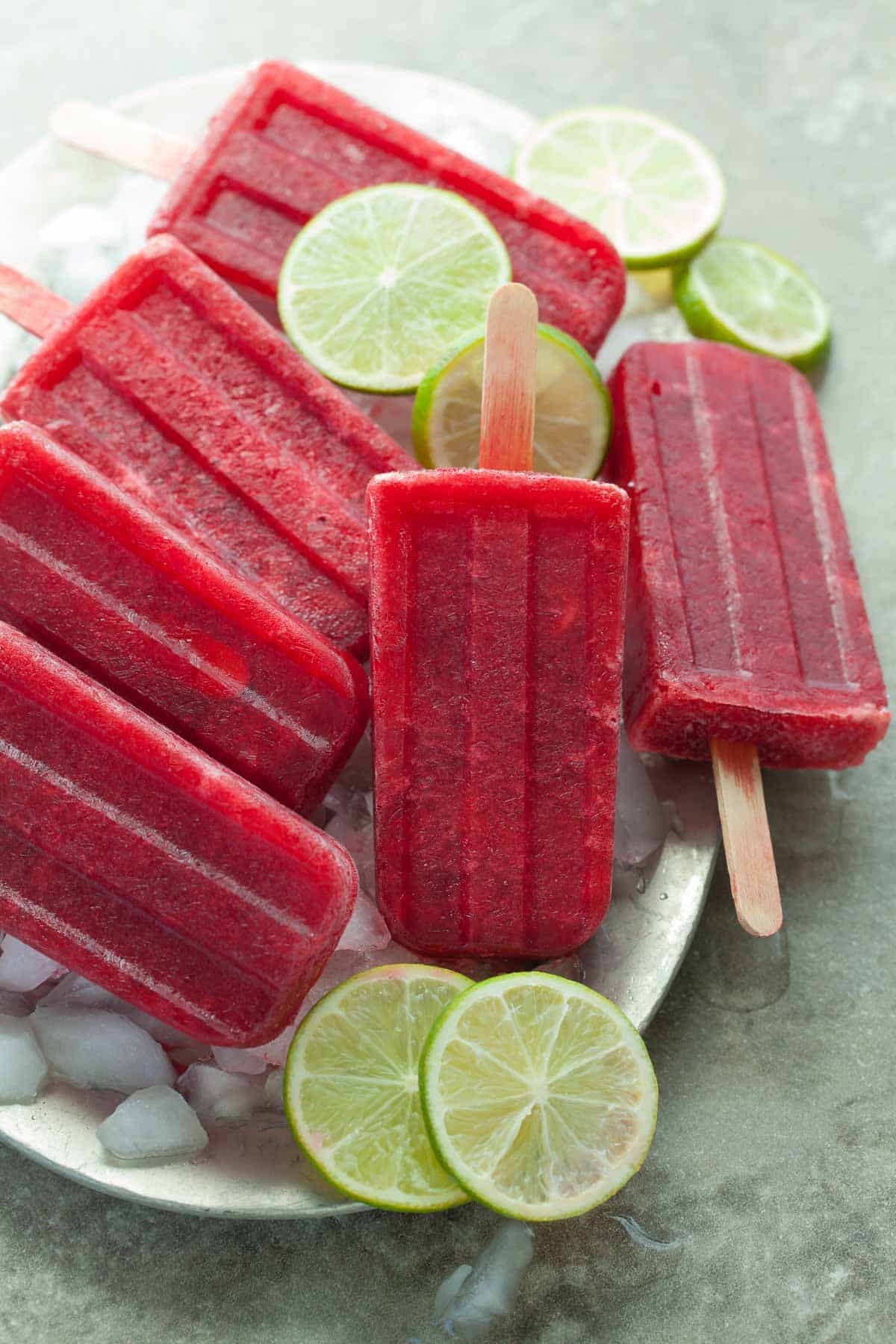 Cherry Lime Popsicles over Ice on Plate