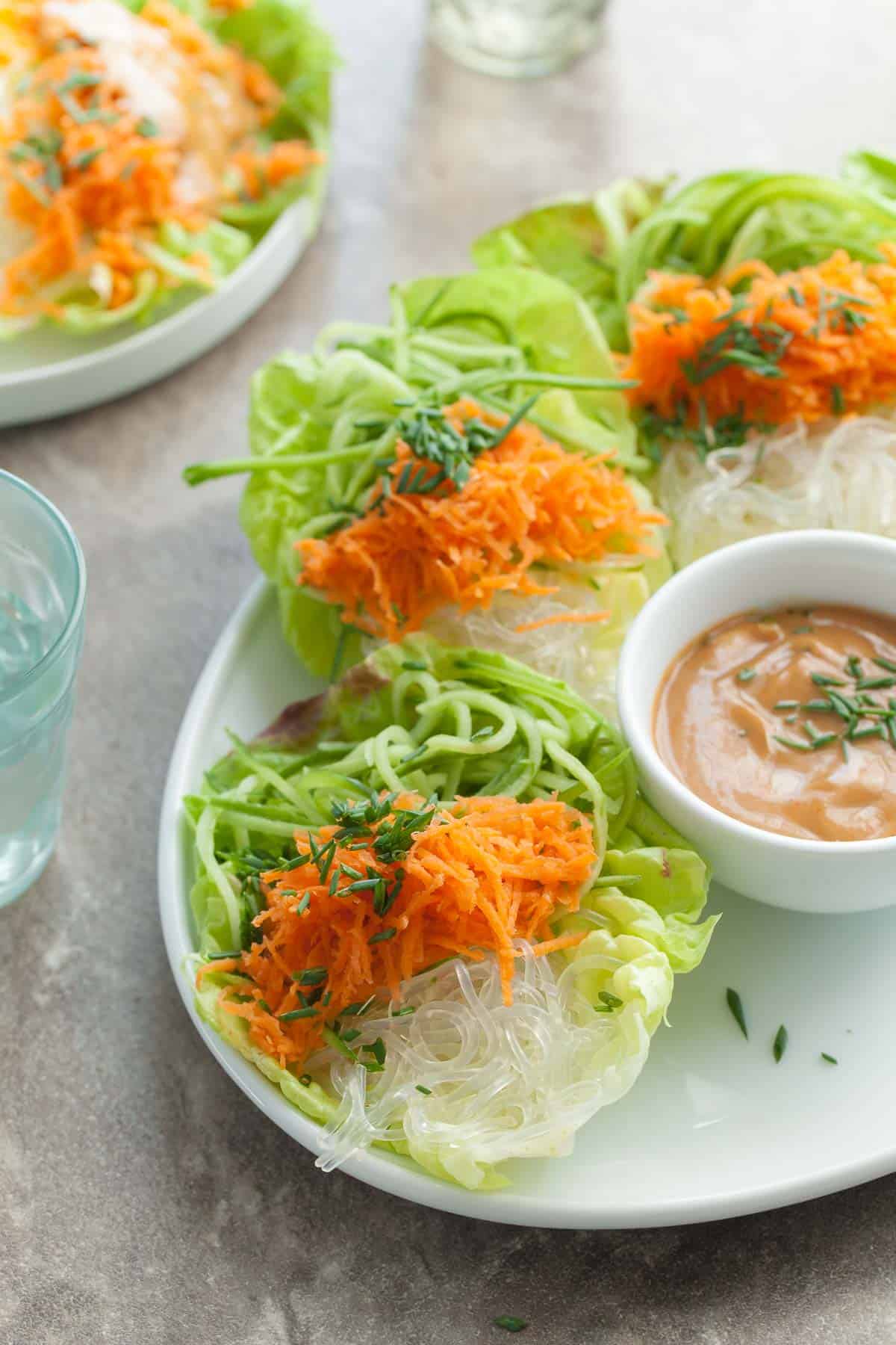 Cucumber and Kelp Noodle Lettuce Wraps with Sesame Sunflower Sauce on White Plates with Sauce