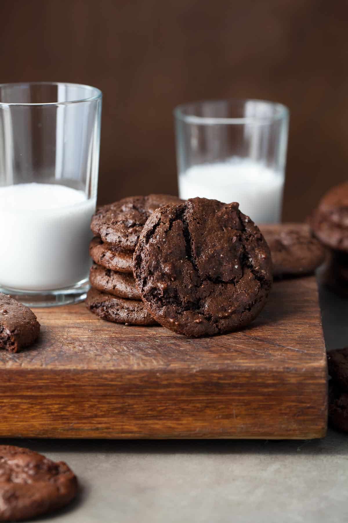 Gluten-Free Chocolate Cookies Stacked Next to Glass of Milk