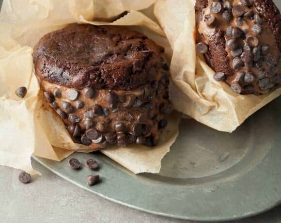Double Chocolate Ice Cream Sandwiches (Vegan, Paleo) - Creamy vegan chocolate ice cream is sandwiched between two double chocolate cookies and rolled in mini chocolate chips.