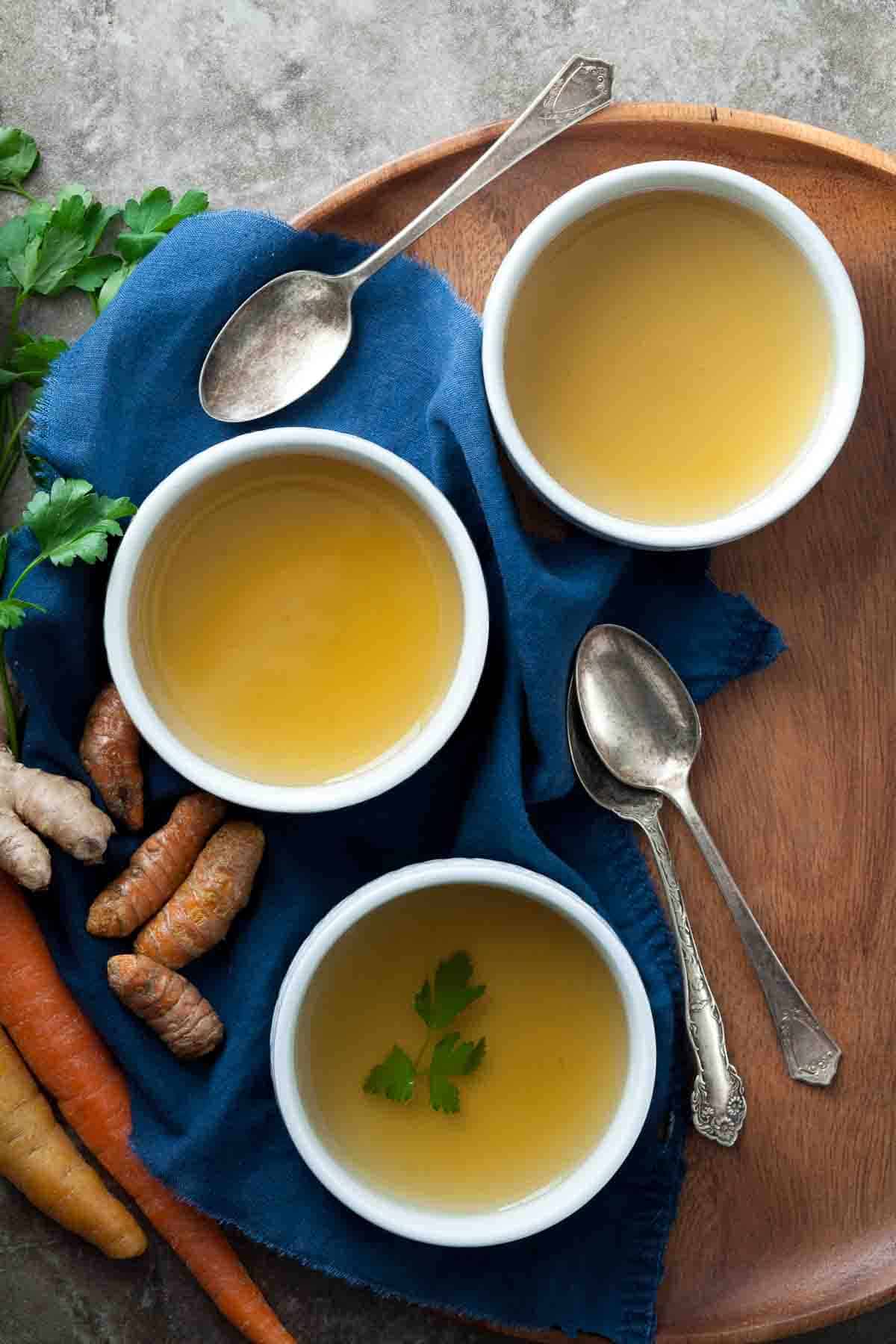 Nourishing Vegetable Detox Broth in Shallow Bowls on Tray