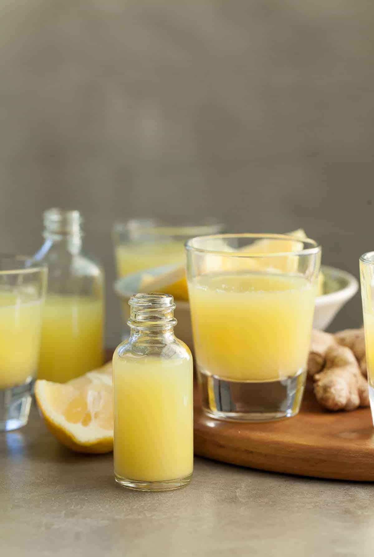 Pineapple Ginger Wellness Shots in Shot Glasses and Bottles