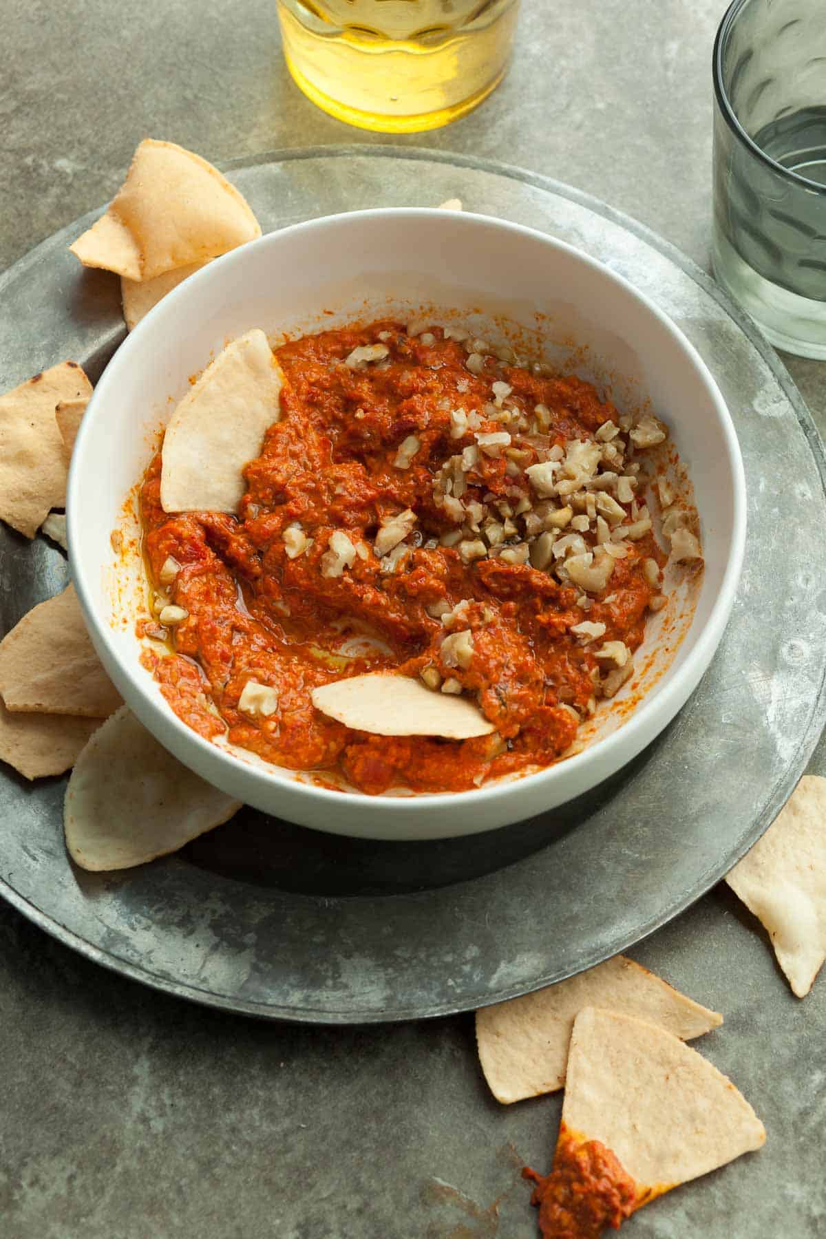 Roasted Red Pepper and Walnut Dip (Muhammara) in Bowl Surrounded by Chips