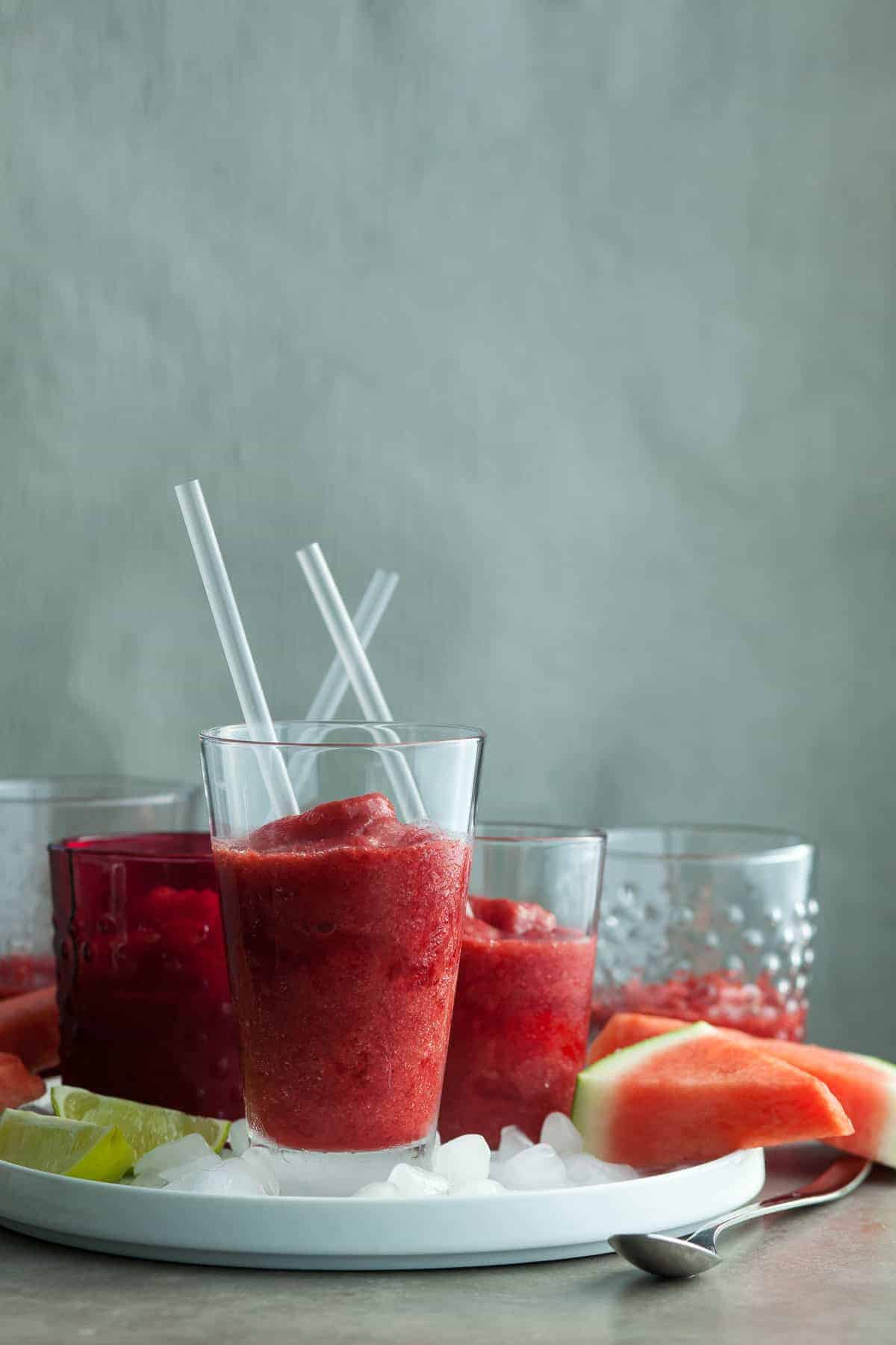 Summer Fruit Slushies on Ice Filled Tray with Straws