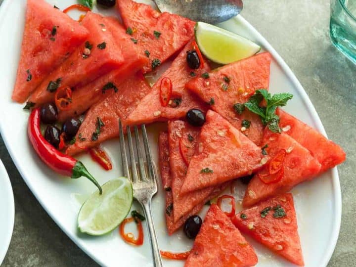 Watermelon Salad with Chili and Mint - Fresh chili peppers add welcome heat to this refreshing summer salad of watermelon, mint and olives. #recipe #salad #healthy #paleo #vegan