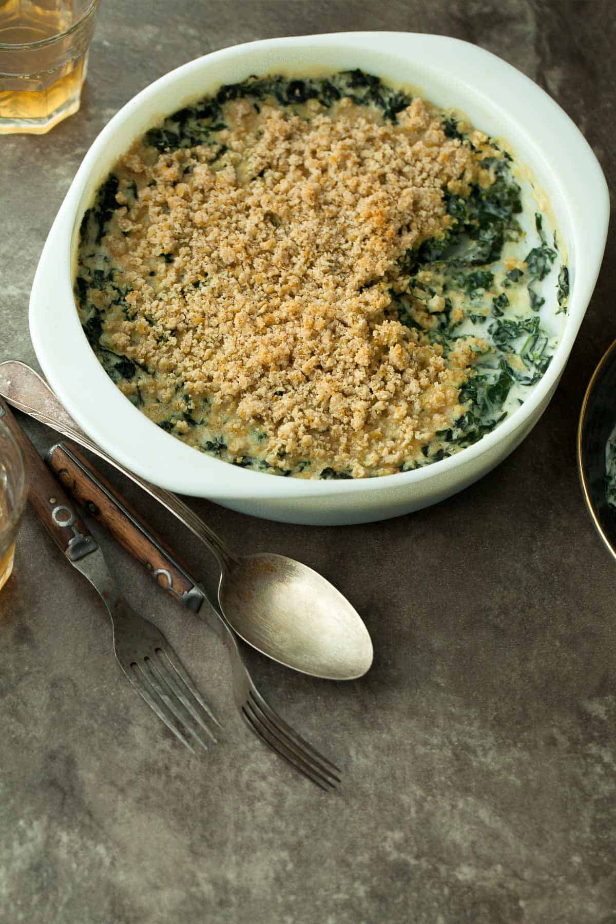 Vegan Creamed Kale in Dish with spoons on the side