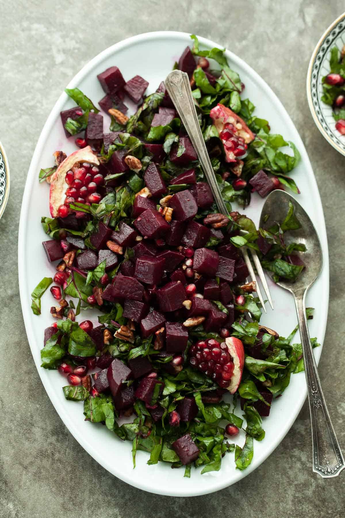 Pomegranate Glazed Beet and Greens Salad on Large White Serving Plate