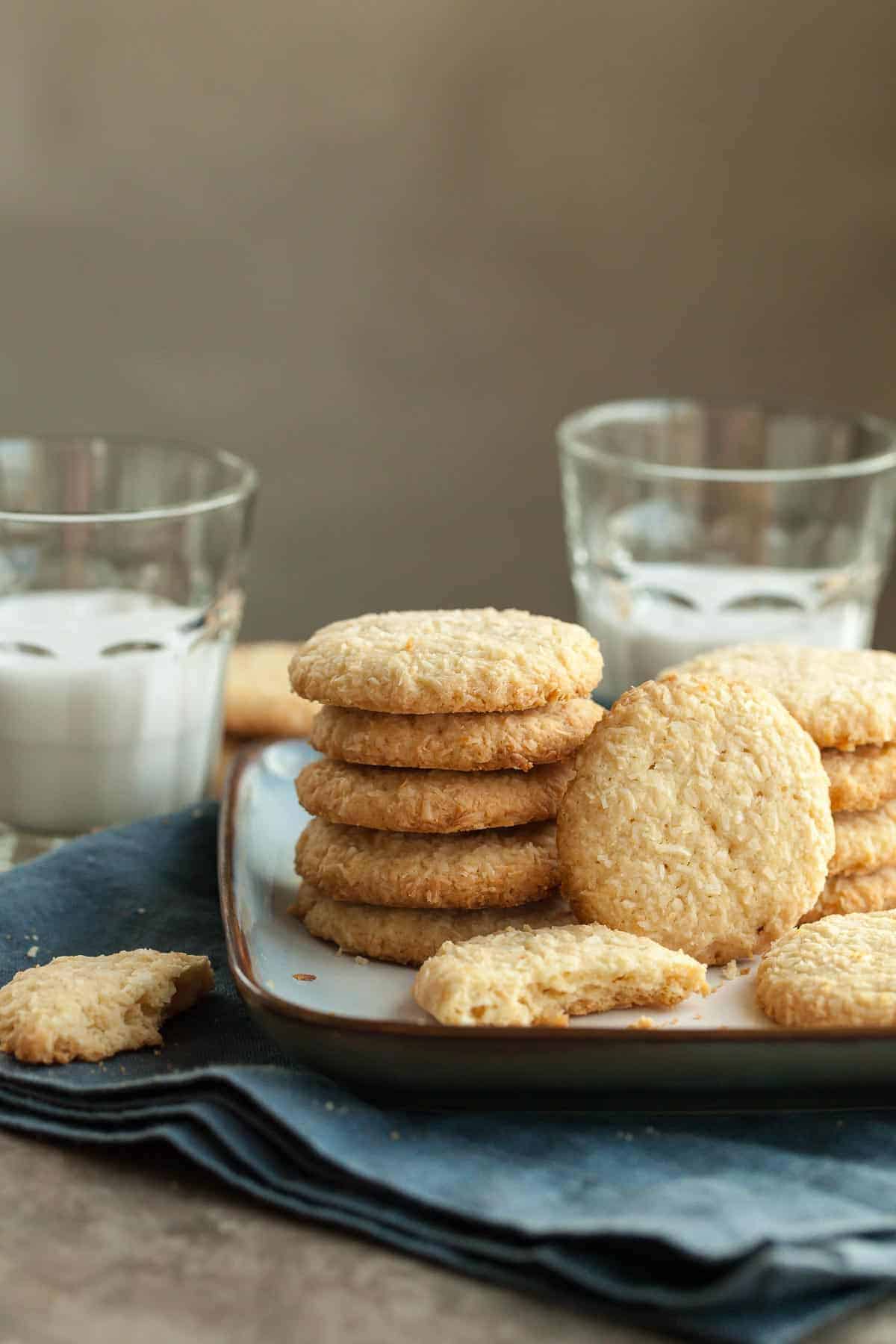 Crispy Coconut Cookies Stacked on Plate