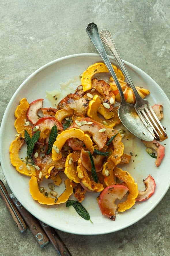 Maple Roasted Delicata Squash and Apples with Crispy Sage on Plate with Serving Spoon