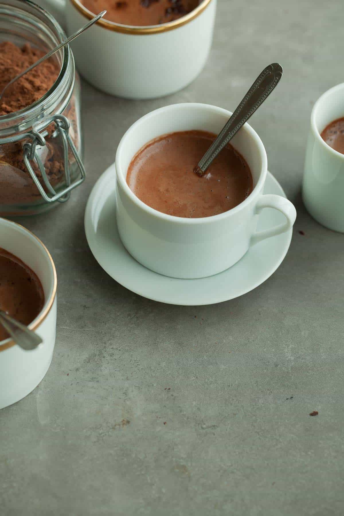 Homemade Hot Cocoa Mix in Cup with Saucer and Spoon