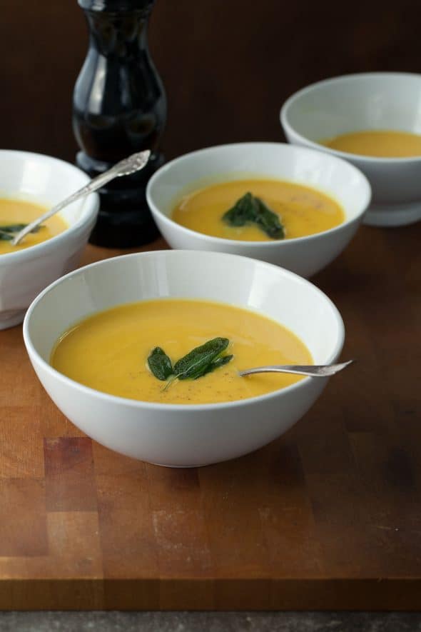 Paleo Golden Winter Root Vegetable Soup in Bowls on Wood Board