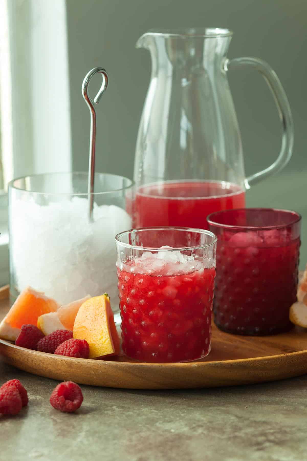 Raspberry Rooibos Grapefruit Iced Tea in Pitcher with ice and glasses