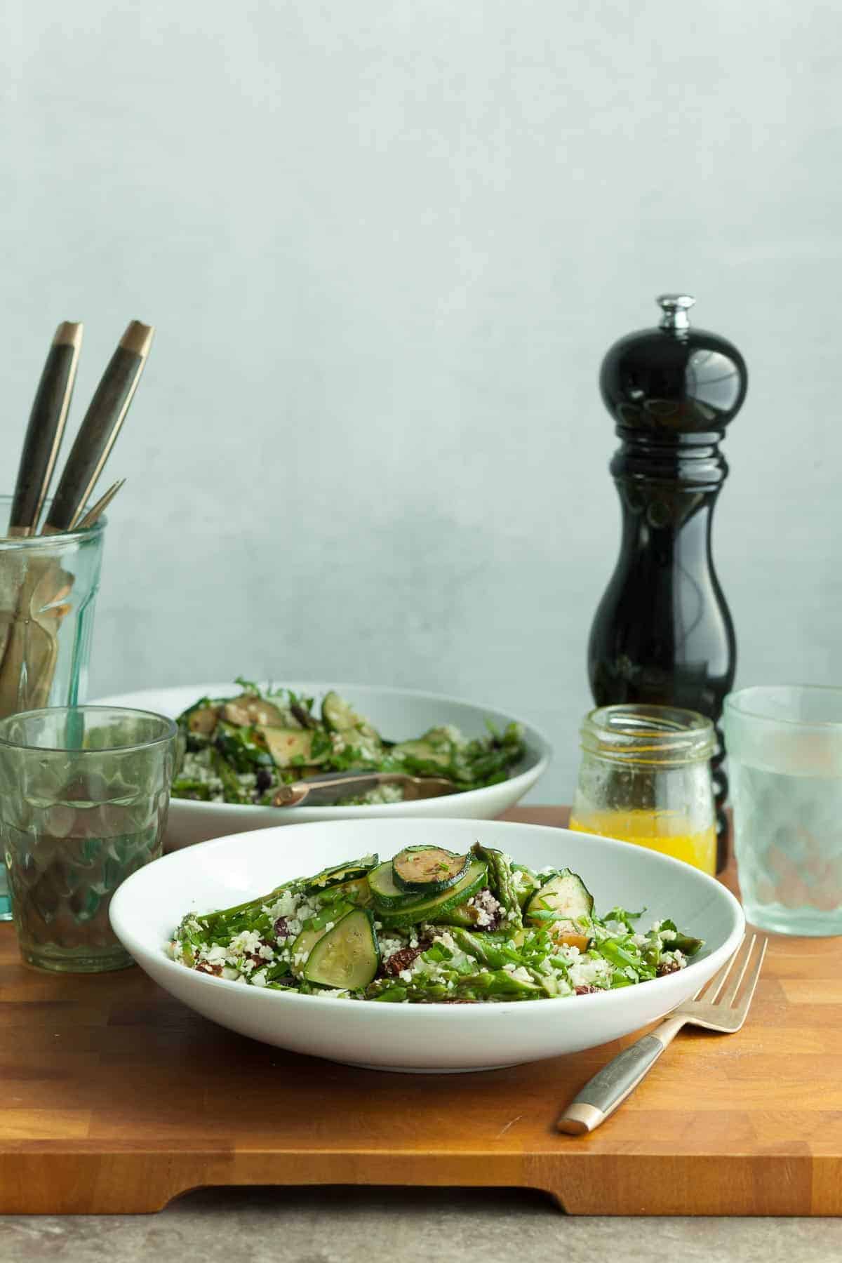 Cauliflower Couscous Salad in Plates with Glasses and Cutlery