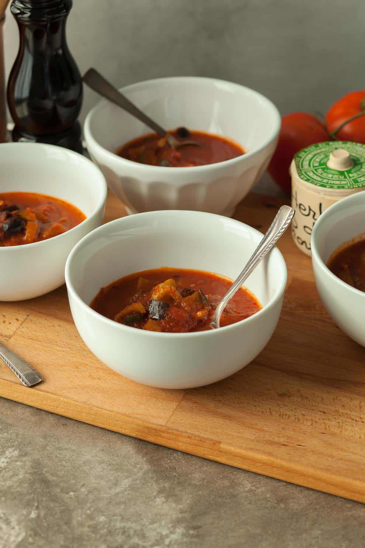 Tomato Vegetable Soup in Bowls on Wood Board 
