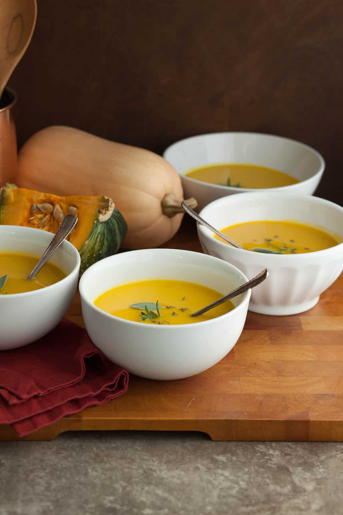 Winter Squash Soup with Red Napkin and Spoons on Board