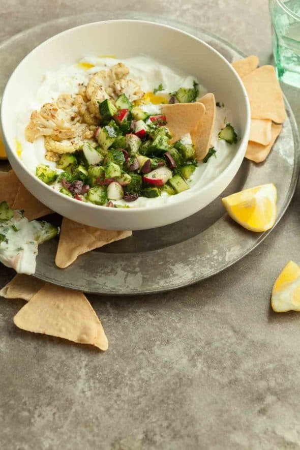 Greek Inspired Savory Yogurt Bowl with Chopped Cucumber Salad and Roasted Caulilfower on Top