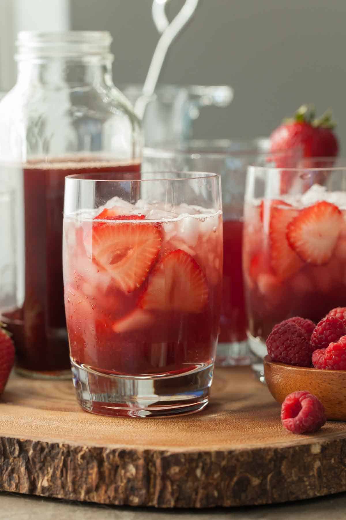 Hibiscus Berry Shrub in Glasses with Strawberry Slices