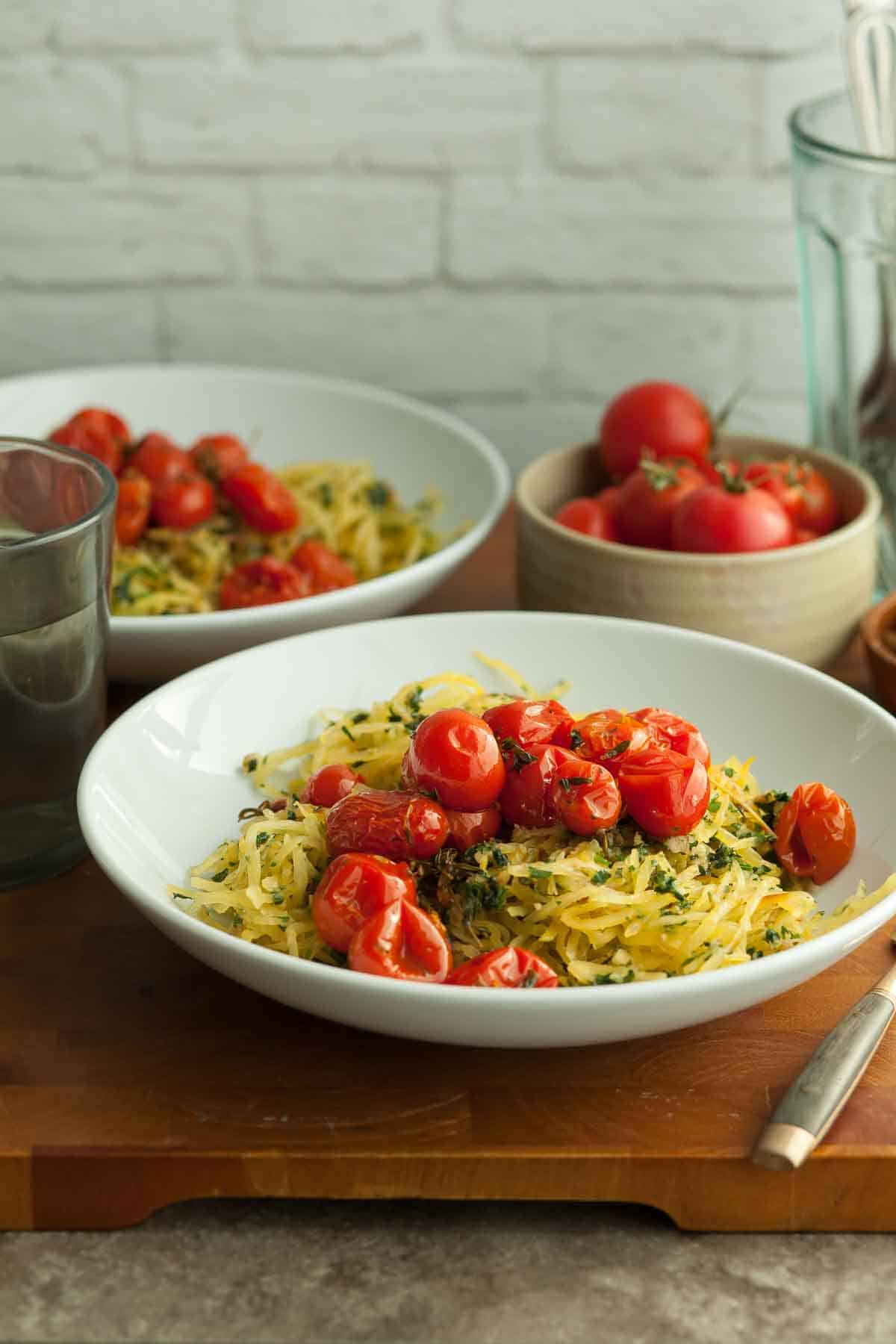 Spaghetti Squash with Roasted Tomatoes in Bowls on Wood Board