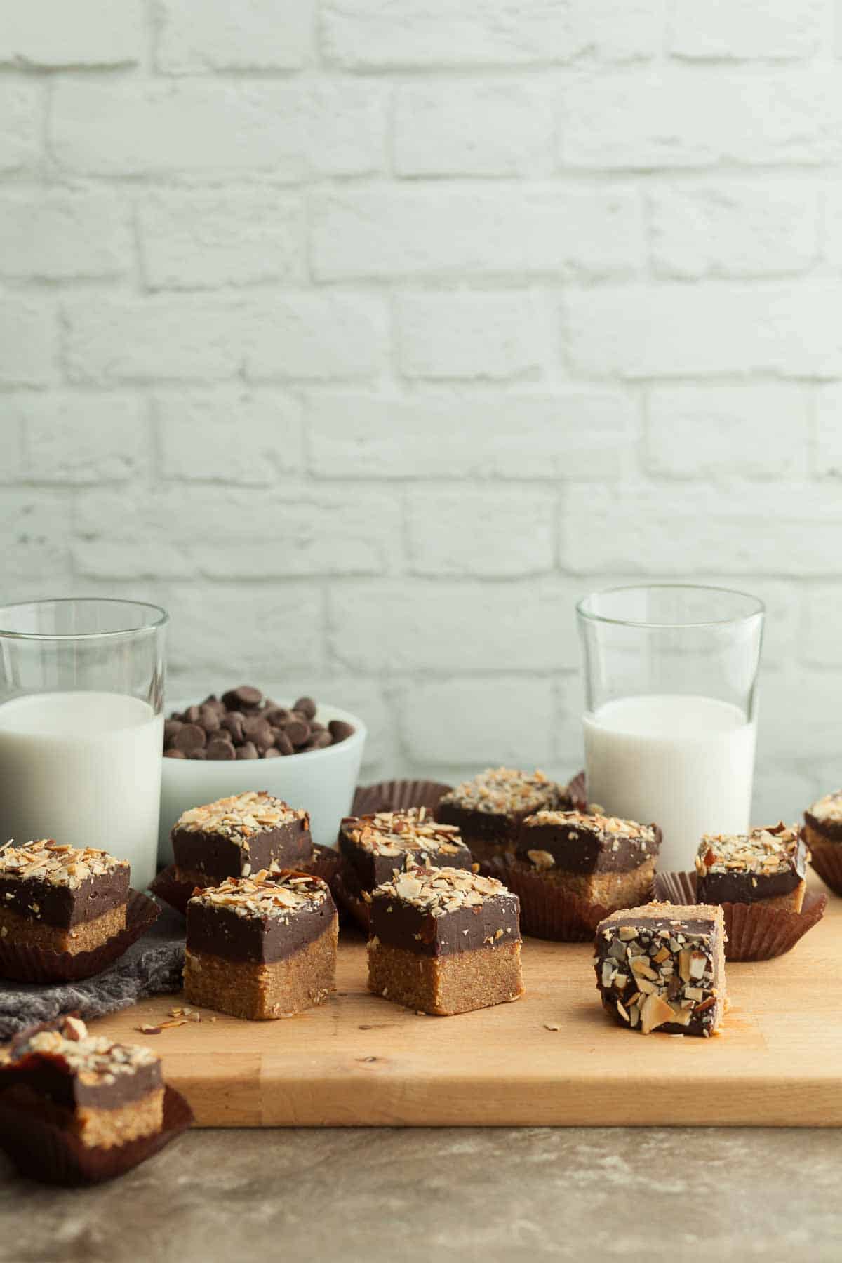 No-Bake Chocolate Almond Butter Bars on Cutting Board Near Milk Glasses