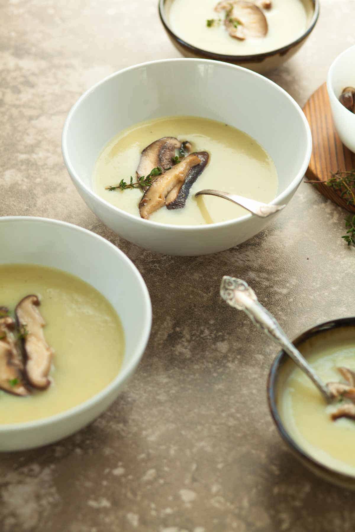 Celery Root and Potato Soup in bowls topped with mushrooms