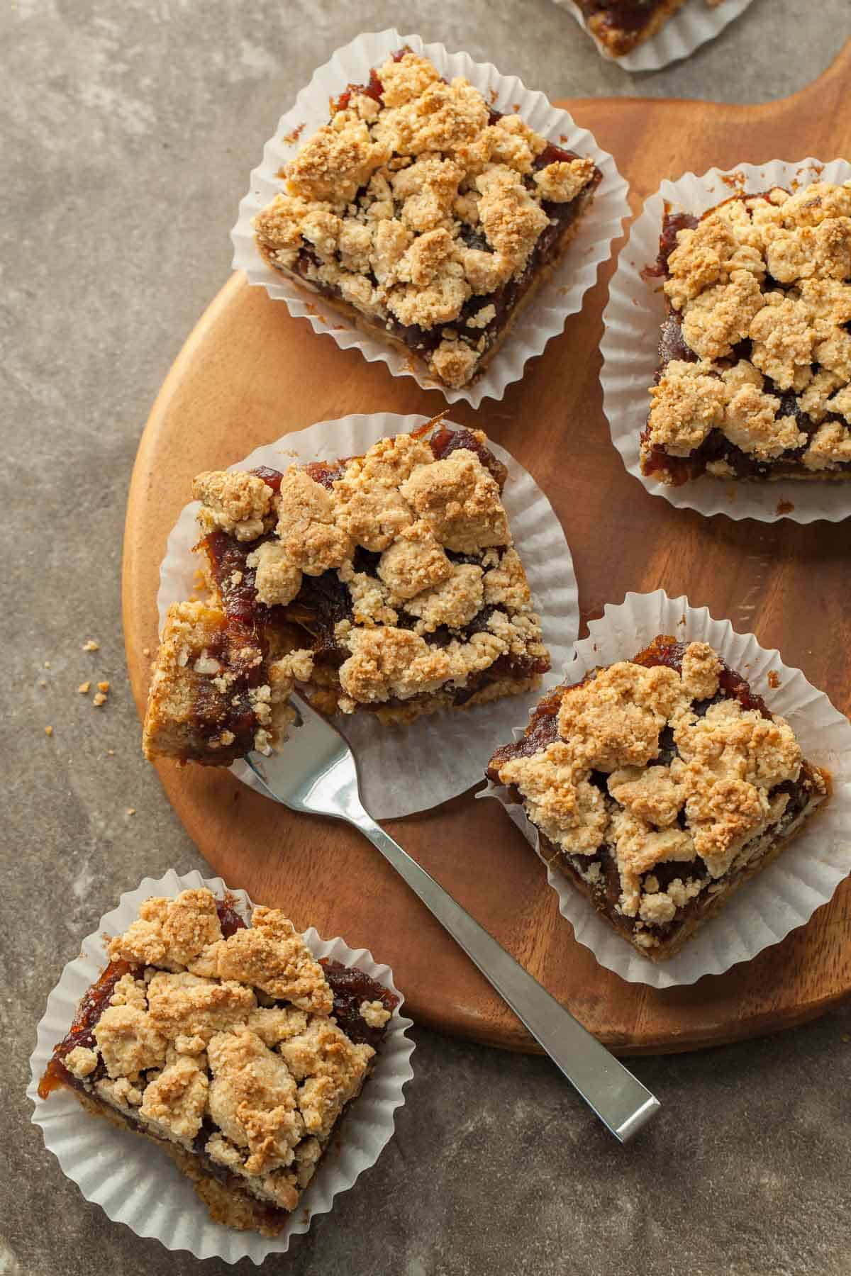 Gluten-Free Pecan Date Bars on board with fork