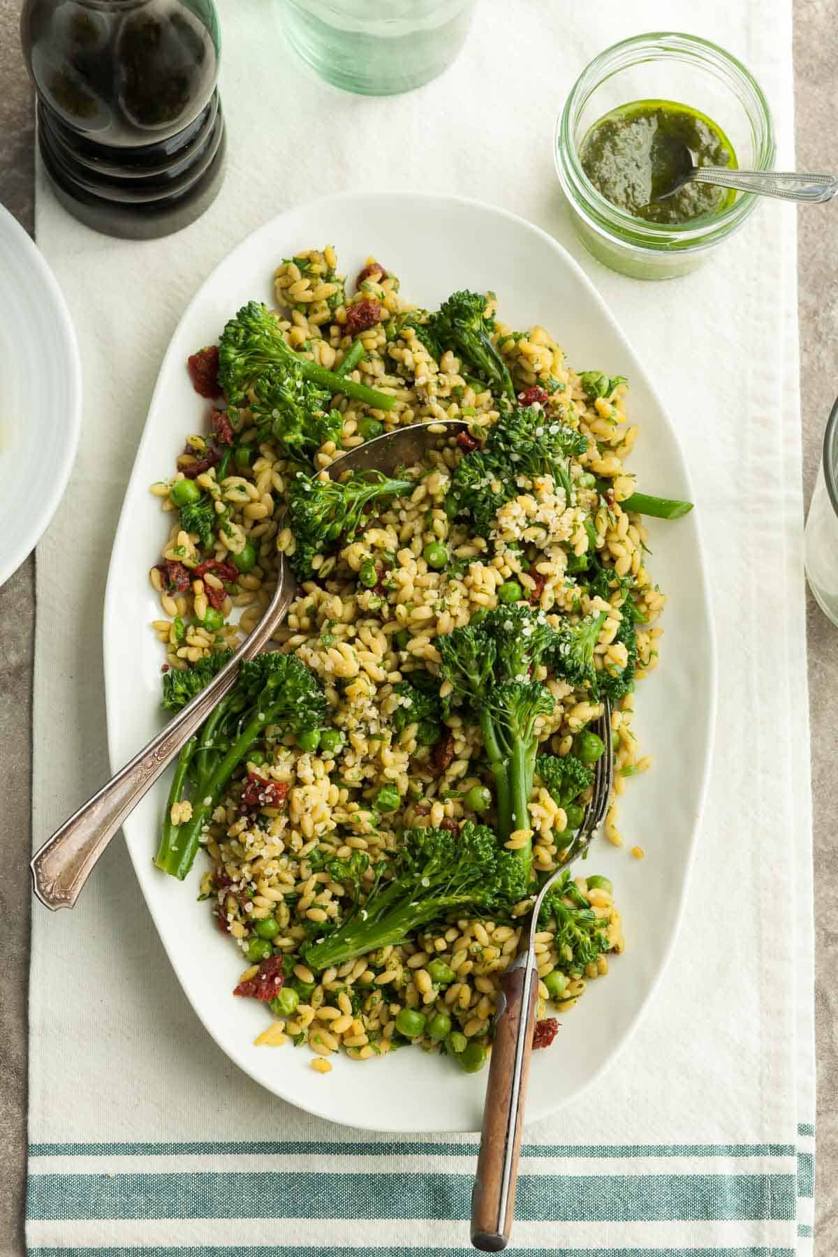 Gluten-Free Orzo (Risoni) Pasta Salad with Pesto and Sundried Tomatoes on Serving Platter