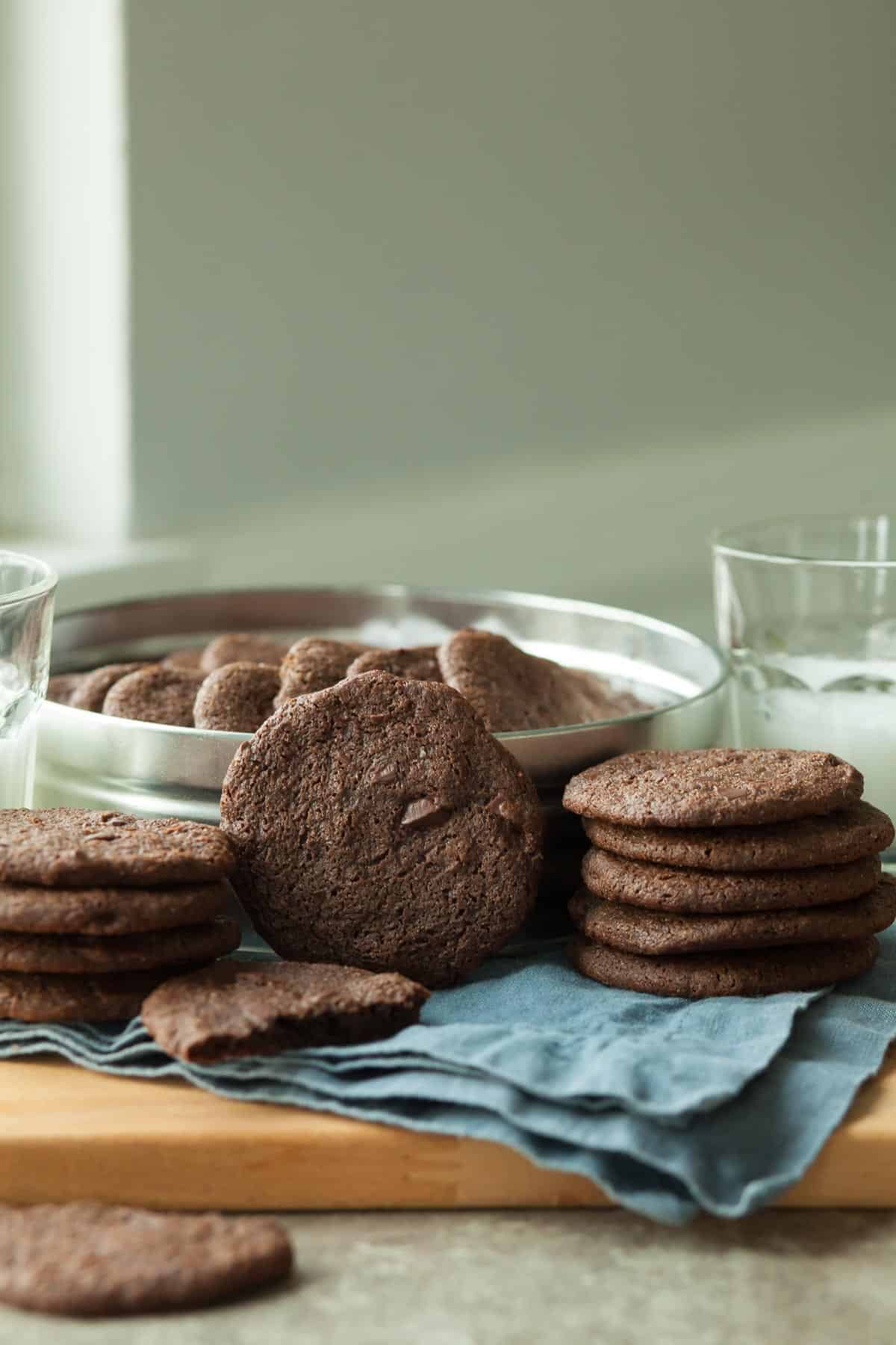 Crispy Chocolate Cookies on Napkin in Front of Cookie Tin