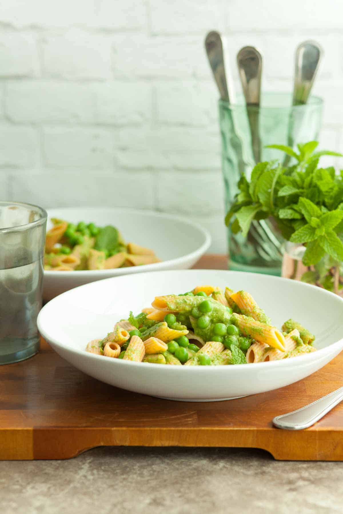 pasta with peas in plates on table