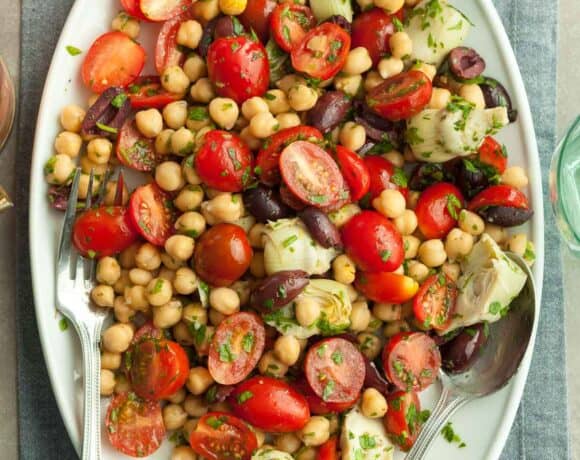 Tomato Chickpea Salad on late with serving utensils