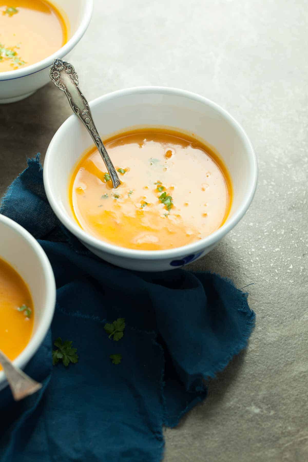 Spicy Sweet Potato Carrot Soup in Bowls with Spoons