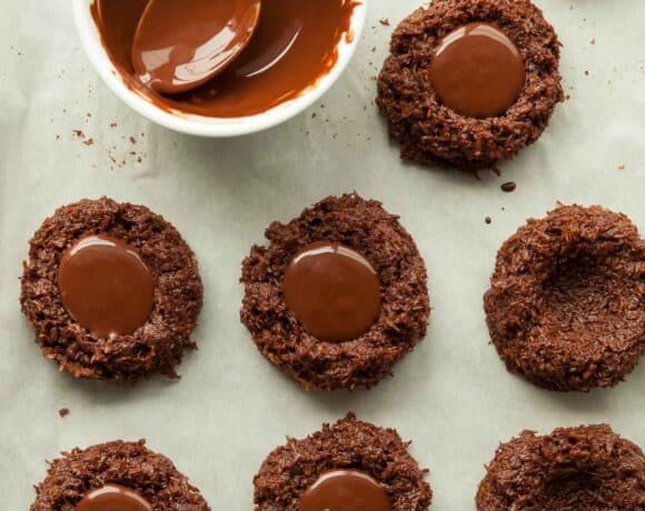 chocolate coconut thumbprint cookies on baking sheet