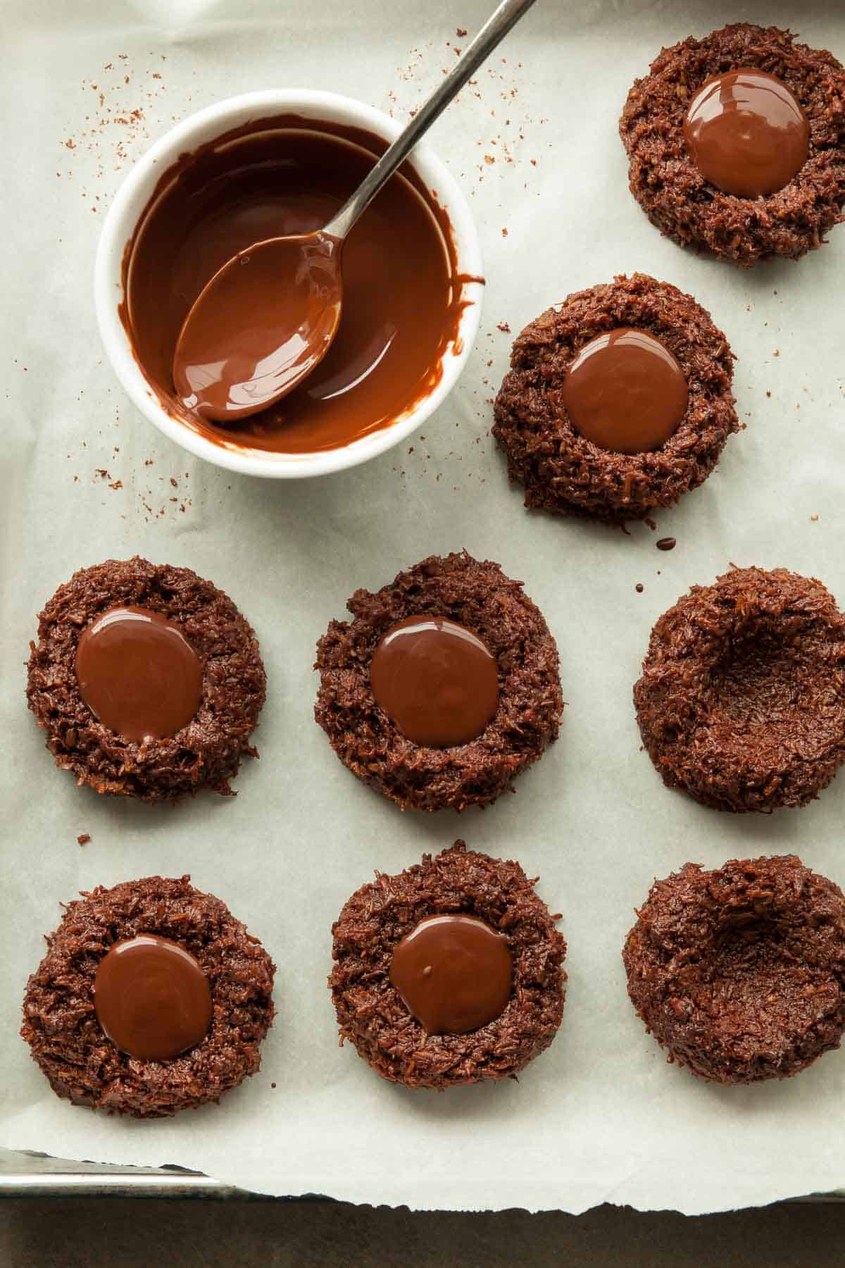 chocolate coconut thumbprint cookies on baking sheet