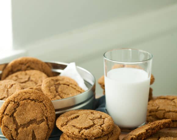 Gluten-Free Molasses Cookies Stacked with Glass of Milk