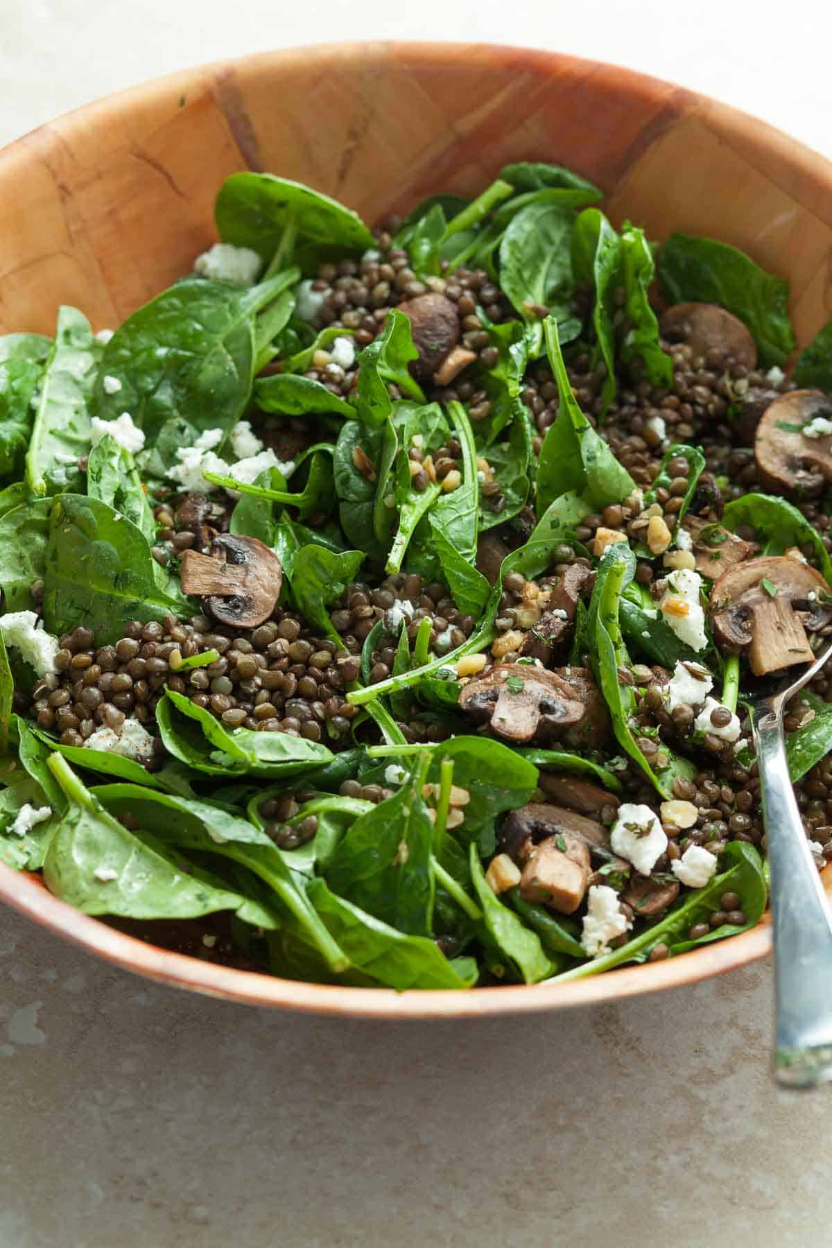 Black Lentil Spinach and Mushroom Salad in Salad Bowl with Serving Spoon