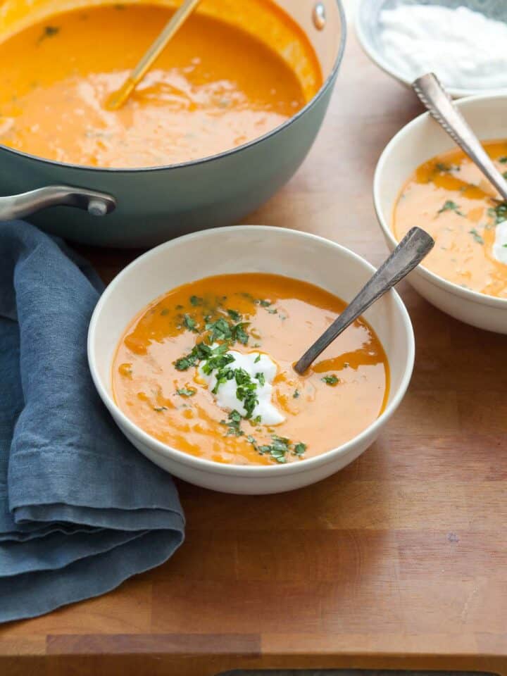 Carrot and Red Lentil Soup in Bowls and Soup Pot