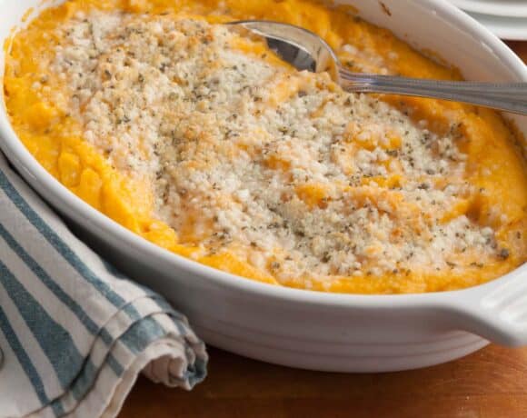 Creamy baked butternut squash topped with fresh sage and melted cheese — an easy make-ahead Thanksgiving recipe.