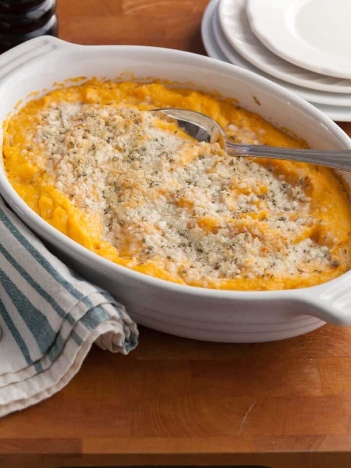 Creamy baked butternut squash topped with fresh sage and melted cheese — an easy make-ahead Thanksgiving recipe.